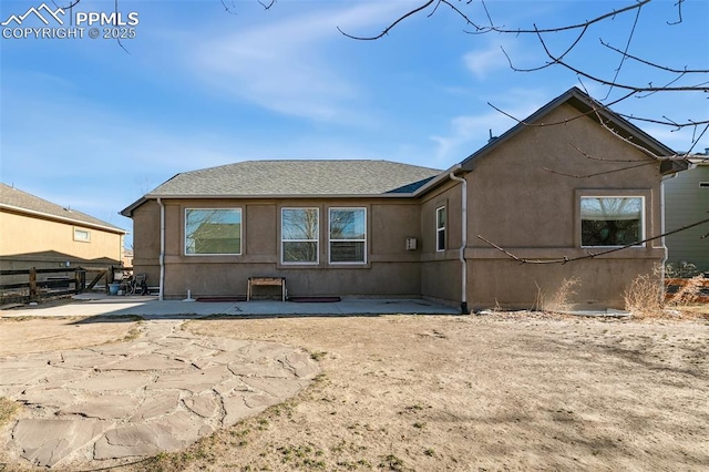 back of property with a patio