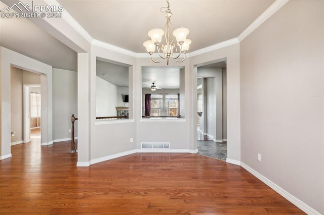 unfurnished dining area featuring hardwood / wood-style flooring, ceiling fan with notable chandelier, and crown molding