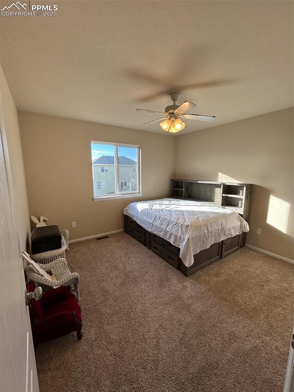 carpeted bedroom featuring ceiling fan