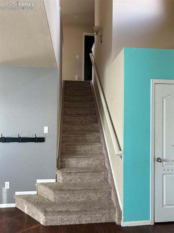 staircase featuring hardwood / wood-style flooring