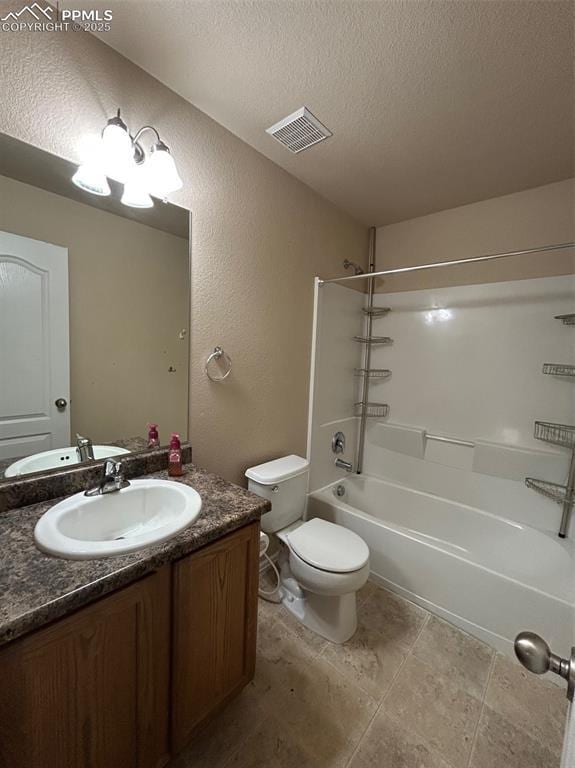 full bathroom with vanity, a textured ceiling, toilet, and shower / washtub combination