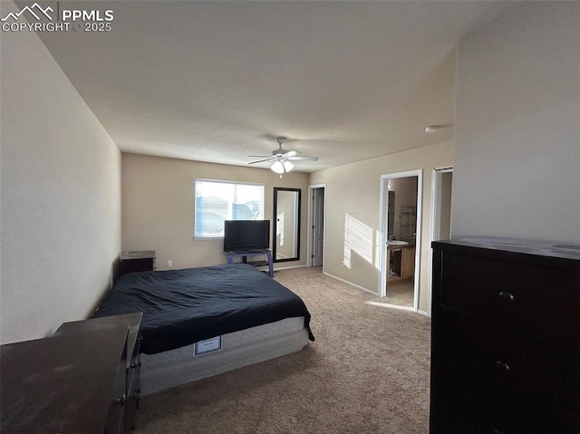 bedroom with carpet floors, ensuite bath, and ceiling fan