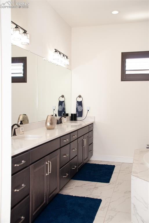 bathroom with plenty of natural light and vanity