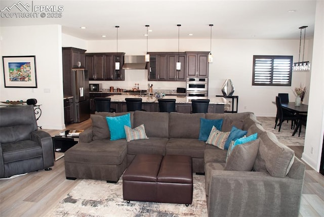 living room featuring light hardwood / wood-style floors and a notable chandelier