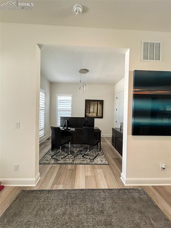 living room featuring hardwood / wood-style floors and a chandelier