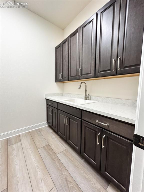 interior space with sink and dark brown cabinets