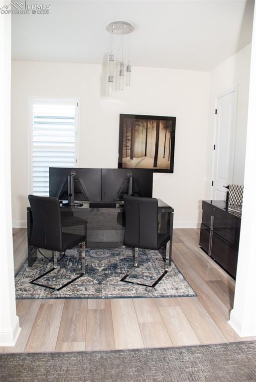 living room with hardwood / wood-style floors and an inviting chandelier