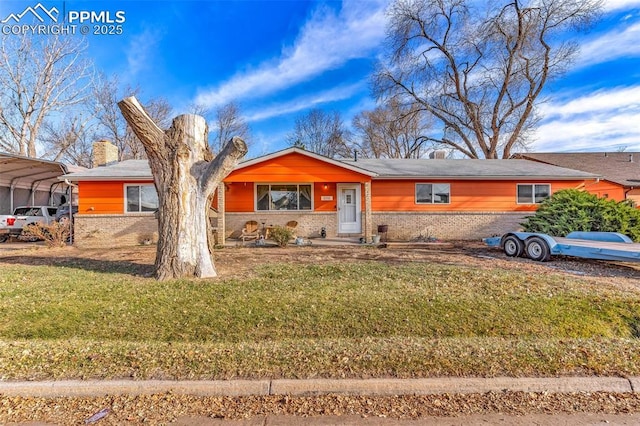 ranch-style house with a front yard and a carport