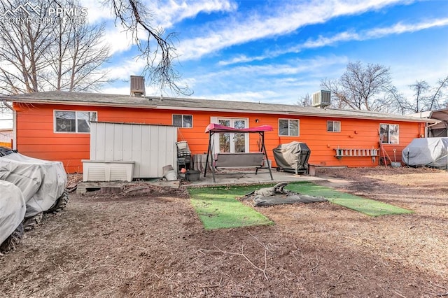 rear view of property with a patio area and cooling unit