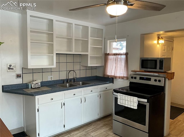 kitchen with white cabinetry, sink, backsplash, ceiling fan, and stainless steel appliances