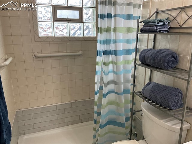 bathroom featuring toilet and a shower with shower curtain