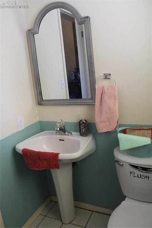 bathroom featuring tile patterned flooring and toilet