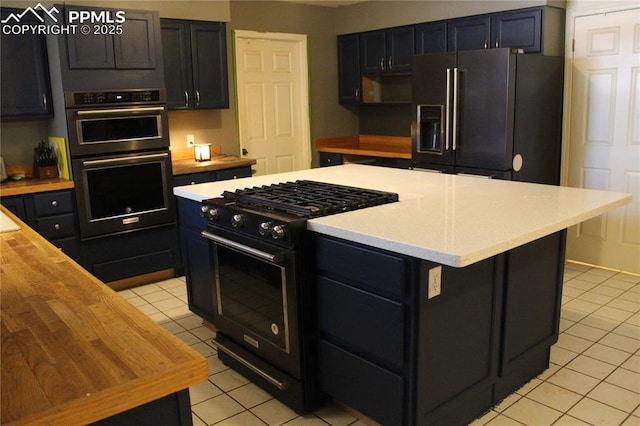 kitchen with high quality appliances, a center island, and light tile patterned floors