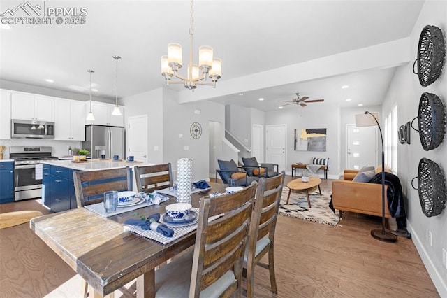 dining area with ceiling fan with notable chandelier and light wood-type flooring