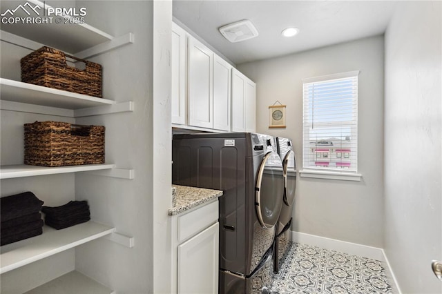 laundry area with cabinets and washing machine and dryer