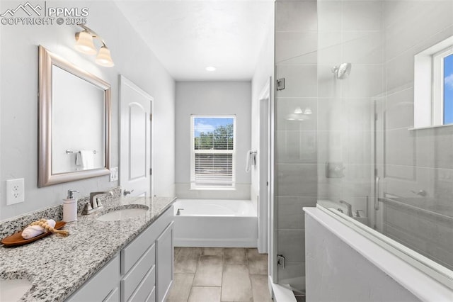 bathroom with vanity and independent shower and bath