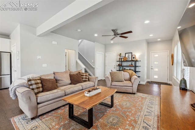 living room featuring ceiling fan, beamed ceiling, and dark hardwood / wood-style floors