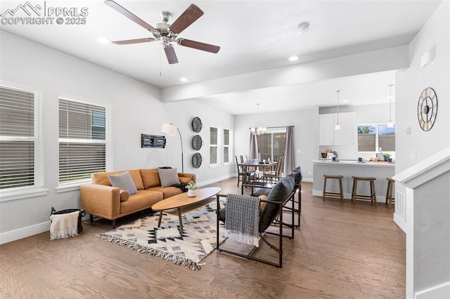 living room featuring wood-type flooring and ceiling fan