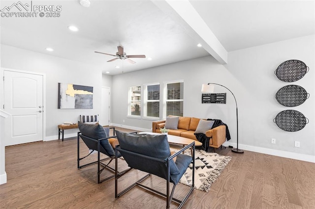 living room featuring ceiling fan, beam ceiling, and light hardwood / wood-style flooring