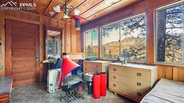 interior space featuring a mountain view, wood ceiling, and wood walls