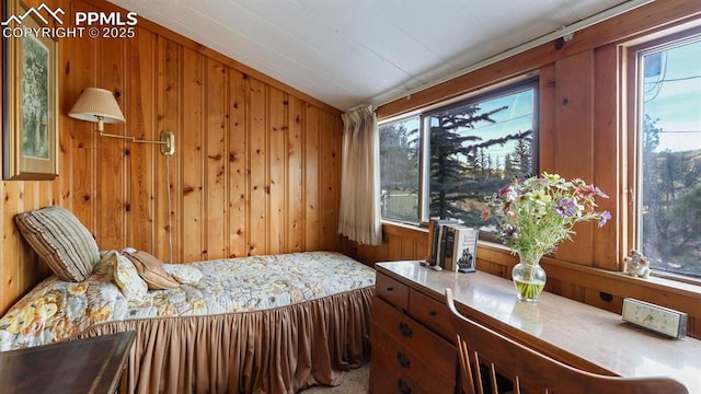 bedroom featuring carpet flooring, lofted ceiling, and wooden walls