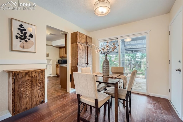 dining area with dark hardwood / wood-style flooring