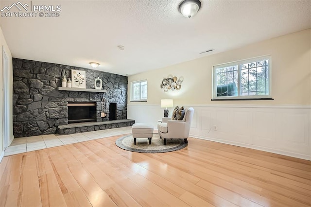 sitting room with a fireplace and hardwood / wood-style flooring