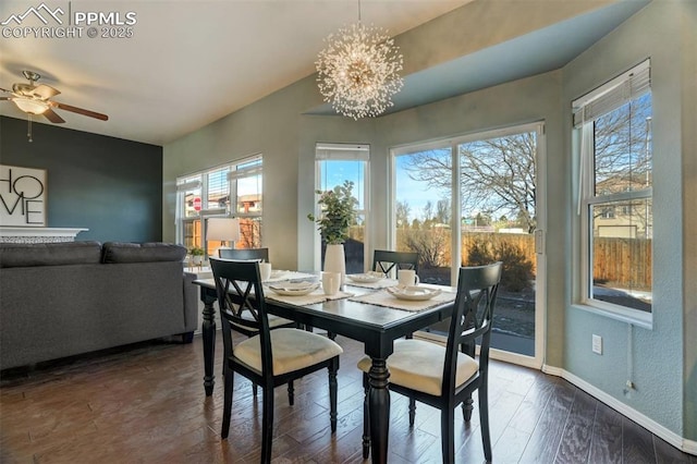 dining room featuring dark hardwood / wood-style flooring and ceiling fan with notable chandelier