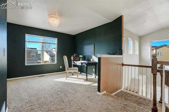 carpeted office space with a chandelier and lofted ceiling