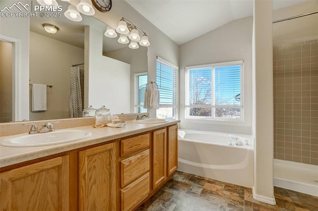 bathroom featuring lofted ceiling, vanity, and shower with separate bathtub