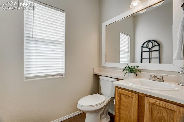 bathroom with toilet and vanity