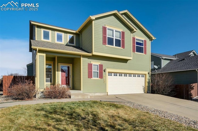 view of front of property with a garage and a front lawn