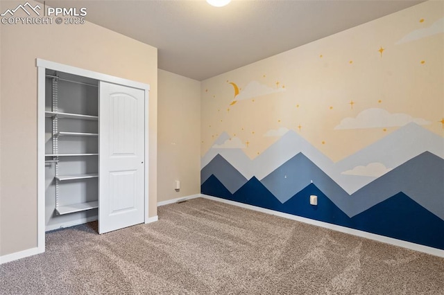 unfurnished bedroom featuring carpet flooring and a closet