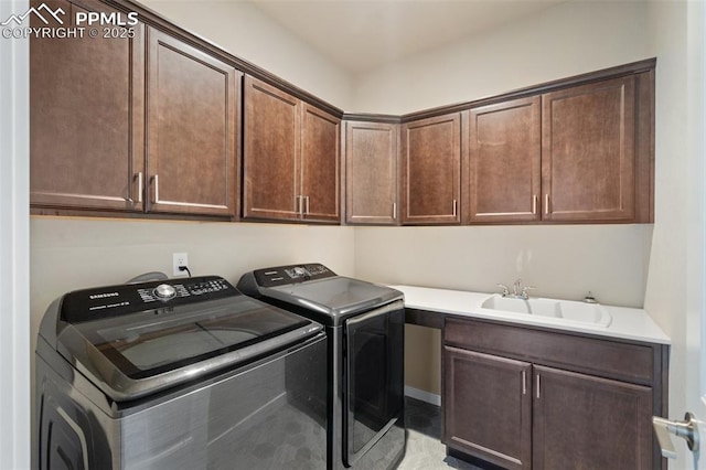 laundry room with cabinets, separate washer and dryer, and sink