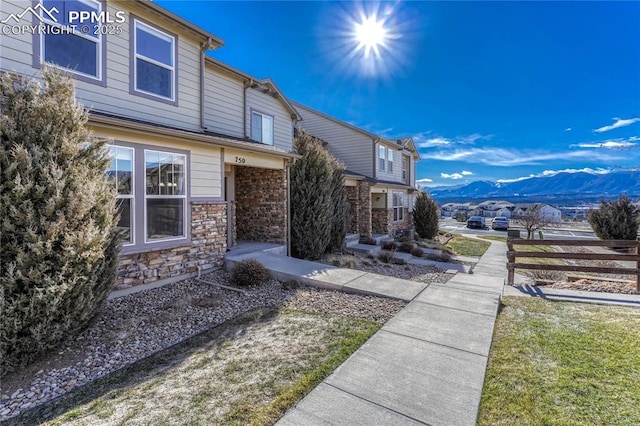 exterior space featuring a mountain view and a front lawn