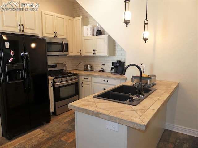 kitchen with sink, white cabinets, stainless steel appliances, and dark hardwood / wood-style floors