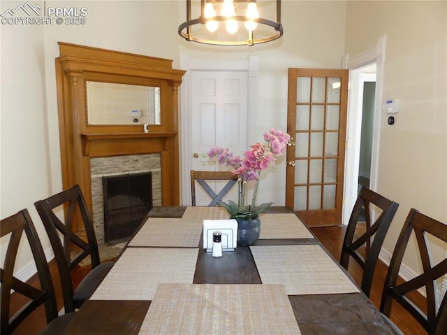 dining room with a stone fireplace and french doors