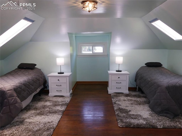 bedroom with lofted ceiling with skylight and dark hardwood / wood-style flooring