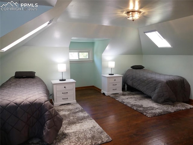 bedroom with dark hardwood / wood-style flooring and vaulted ceiling with skylight