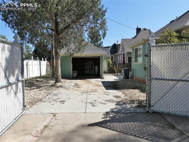 exterior space featuring a garage and an outbuilding