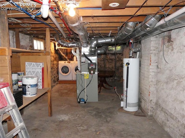 basement featuring heating unit, independent washer and dryer, and water heater