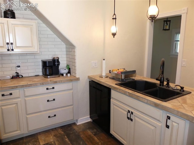 kitchen with white cabinets, decorative light fixtures, black dishwasher, and sink