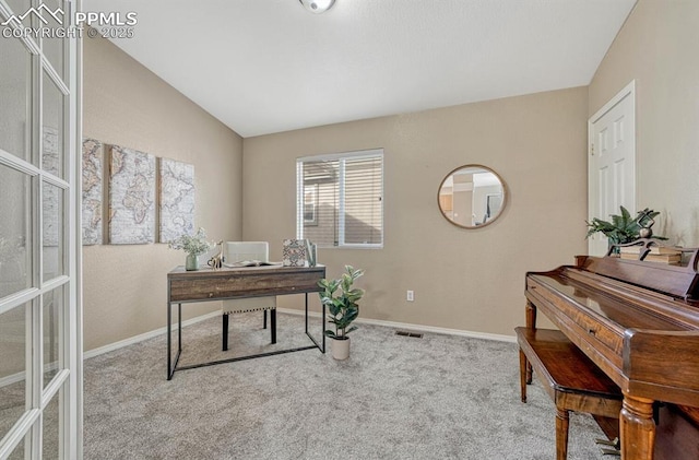 carpeted office space featuring lofted ceiling