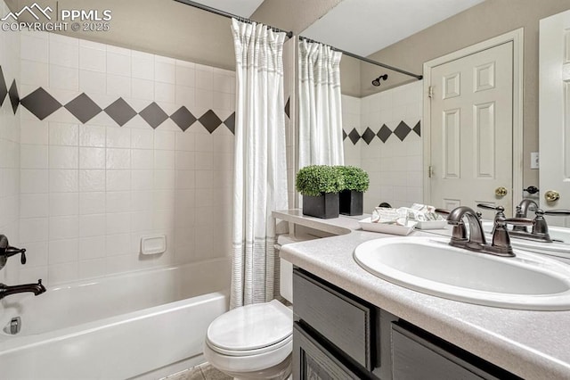 full bathroom featuring shower / bath combination with curtain, vanity, and toilet