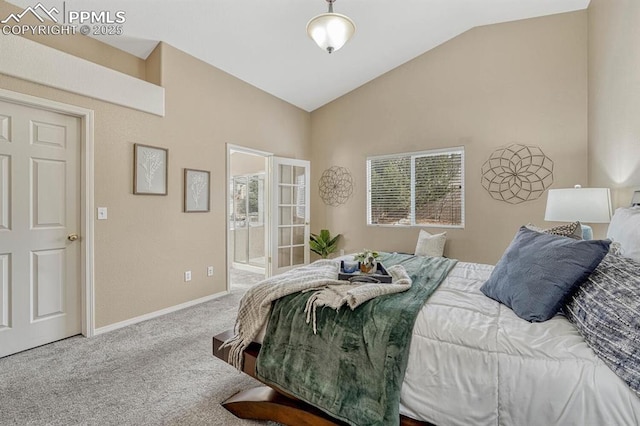 carpeted bedroom featuring ensuite bathroom and vaulted ceiling