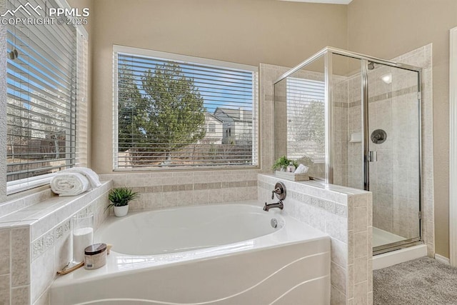 bathroom featuring separate shower and tub