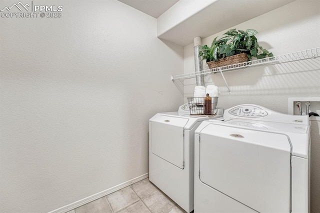 washroom with washing machine and dryer and light tile patterned floors