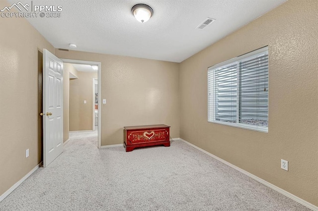 spare room featuring a textured ceiling