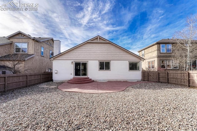 back of property with a patio