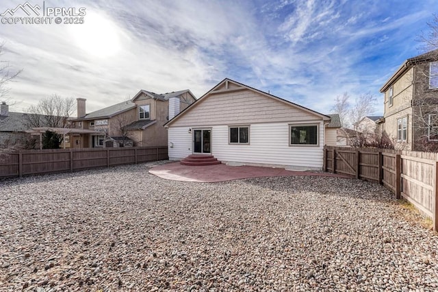 back of property with a patio